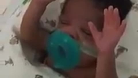 Baby takes an amazing attitude when his mother starts to sing. It's chilling!