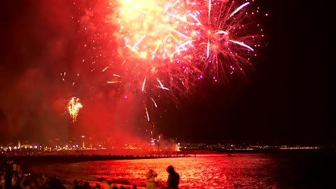 Fireworks illuminating the beach sky