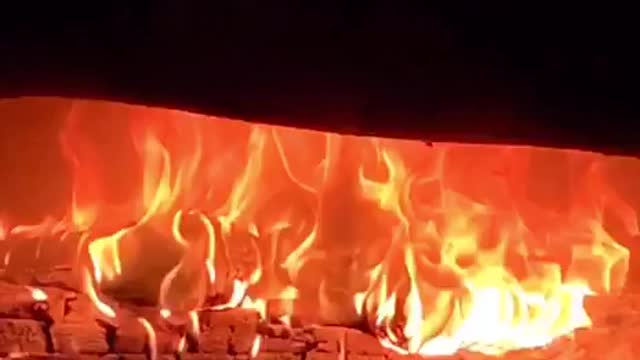 A beautiful flame burns in the fireplace.