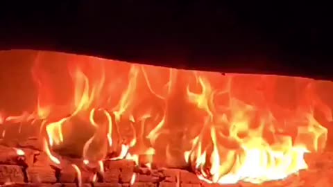 A beautiful flame burns in the fireplace.