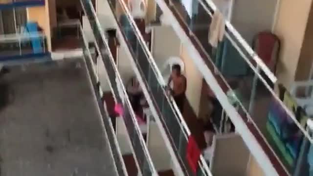 Wooden chair thrown into hotel pool from balcony