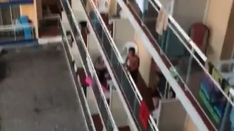 Wooden chair thrown into hotel pool from balcony