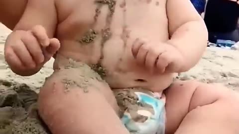 A baby play in the beach with very funny moment