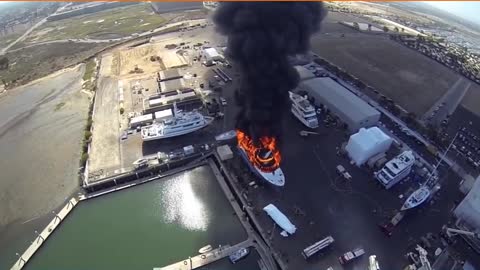 Yacht On Fire In Shipyard - Aerial View From Drone