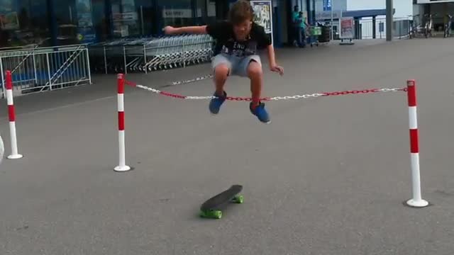 Two blonde kids jumping over rope on skateboard second kid trips on rope