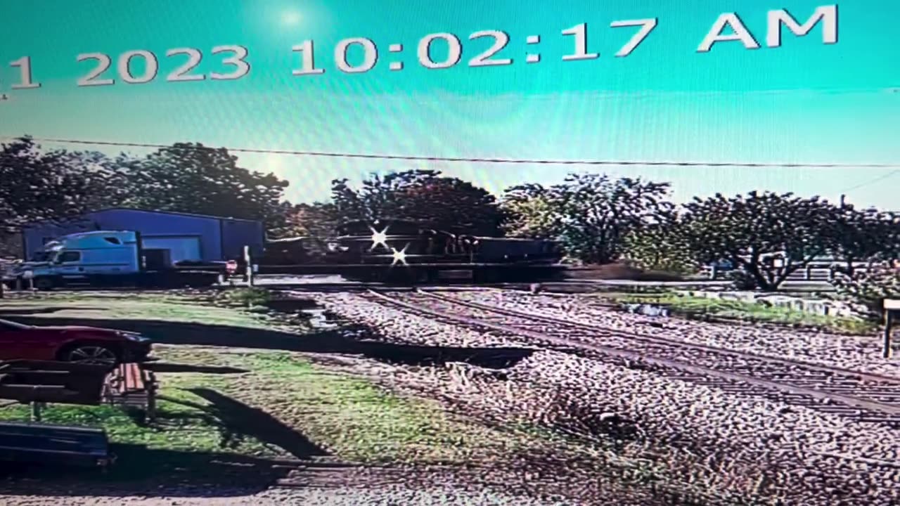 A Trailer And Train Meet On The Tracks