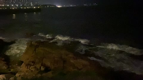 By the sea at night