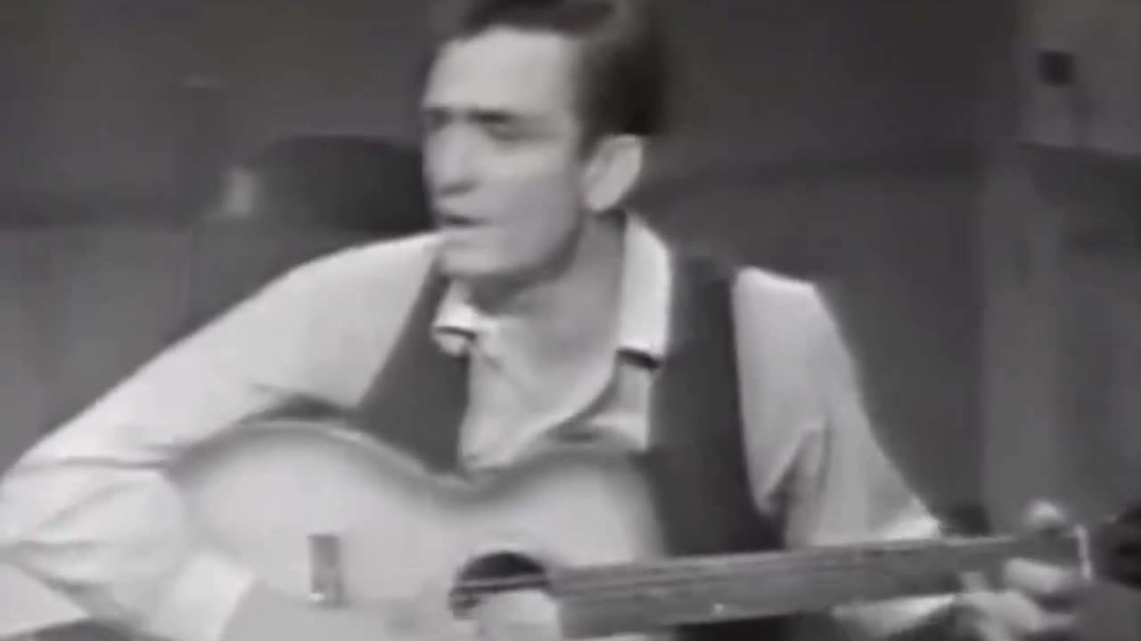 Johnny Cash, on a talk show, shoes off, chain-smoking, high, sings about his farm flooding in 1937