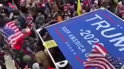 Another angle of Ray Epps pushing the sign into police