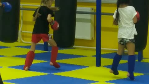 A little girl loves kickboxing very much