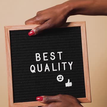 A Person Holding a Changeable Felt Letter Board