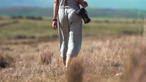 A Woman Taking Photos In The Wilderness