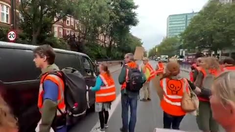 Driver Refuses to Stop for Climate Activists Blocking the Road—Forces His Way Through