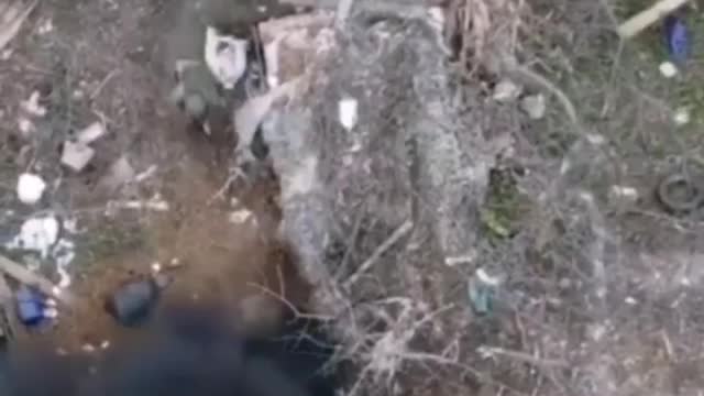 Russian soldiers clean a network of trenches.