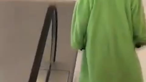 Green wizard walks down stairs