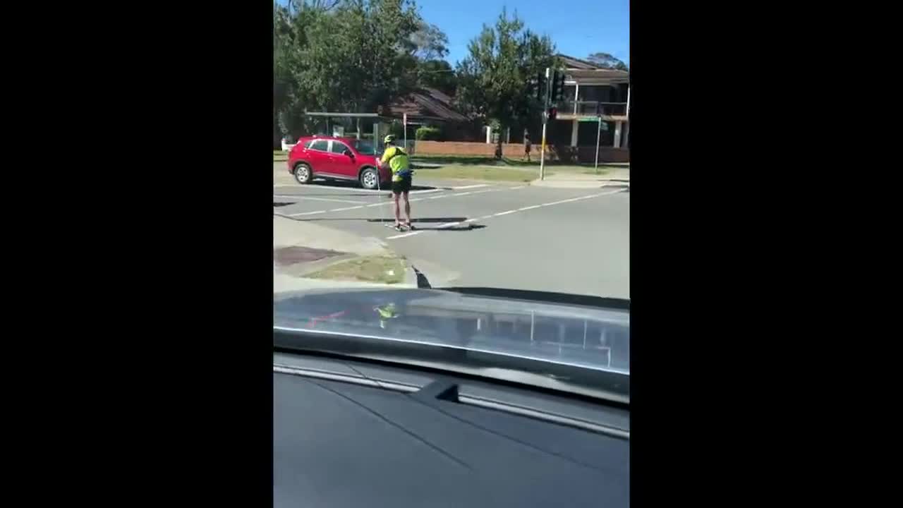 Motorist spots guy 'skiing' through streets of Sydney during summer