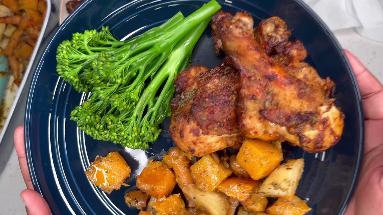 A simple dinner chicken with complementary sides of squash and potatoes and broccolini