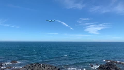 Airplane passing over the sea