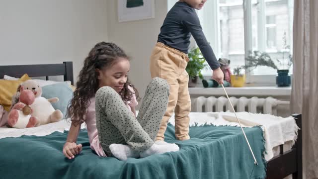 A white cat is playing with children