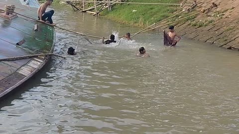 The boys went down to the river and started bathing in the hot weather.