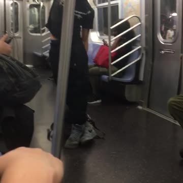 Guy black shirt black pants doing pulls up in subway train