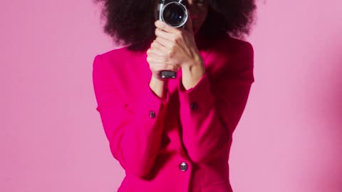 a-young-woman-walking-with-a-video-recorder-on-hand
