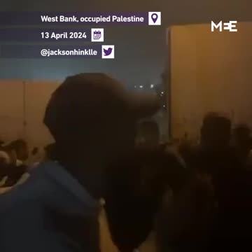 Palestinians could be seen tearing down the separation wall in West Bank