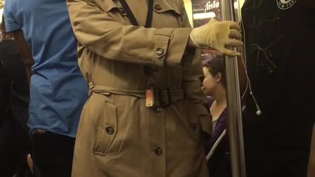 Old man in glasses and trench coat on train