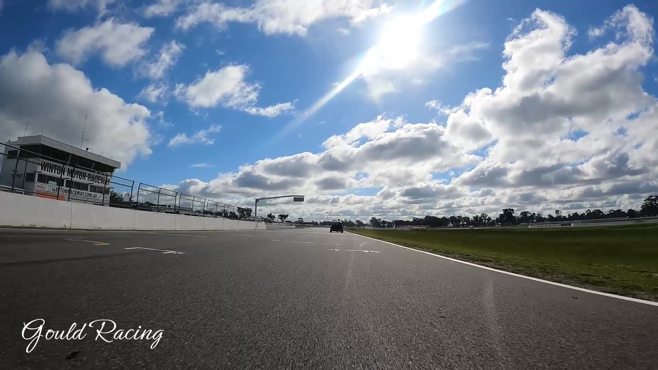 E30 chasing down a Mini at Winton