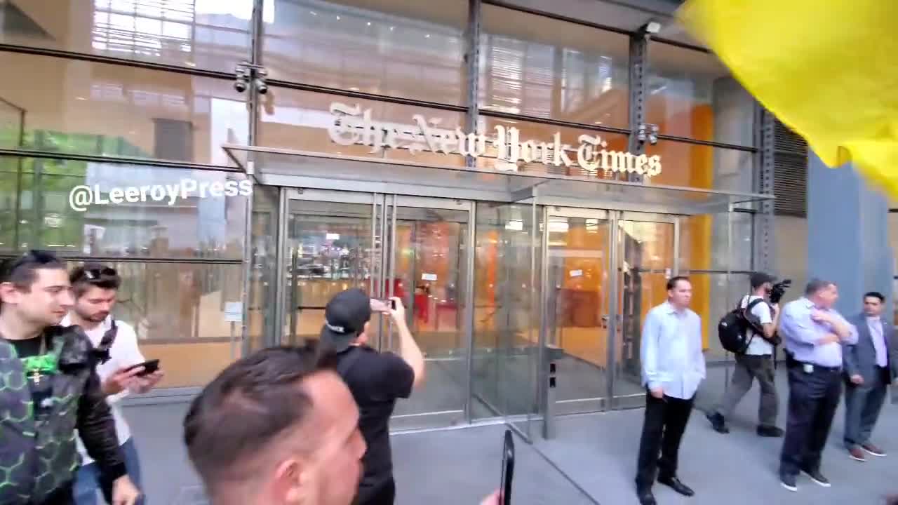 Protesters against vaccine mandates chant "Defund the Media" in front of the New York Times.