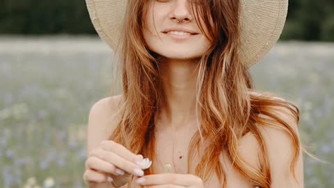 A Woman In The Middle Of The Grass Flower Field