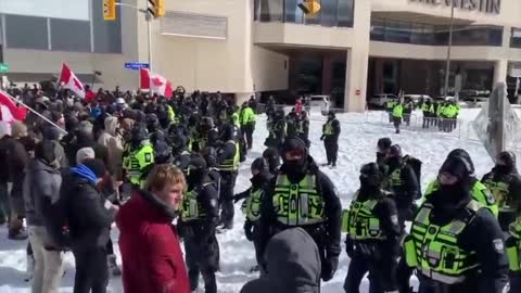 CANADIANS SING NATIONAL ANTHEM TO POLICE LINE