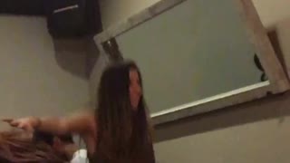 Music girl in white pants falls off chair while dancing