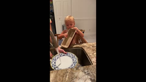 Toddler helping mommy with the dishes