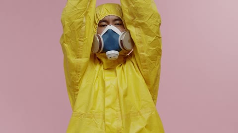 Man in Yellow Protective Suit Doing Meditation