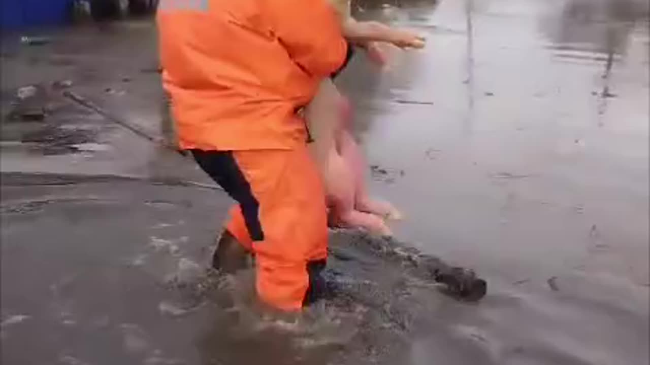 Firemen Carry Russian Soldiers to Safety During Flood
