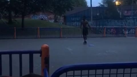 Guy dunks on basketball net lets go and falls on back