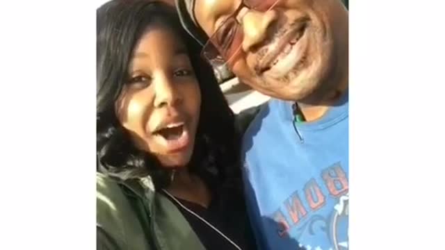 Father gives camera the middle finger while daughter is talking