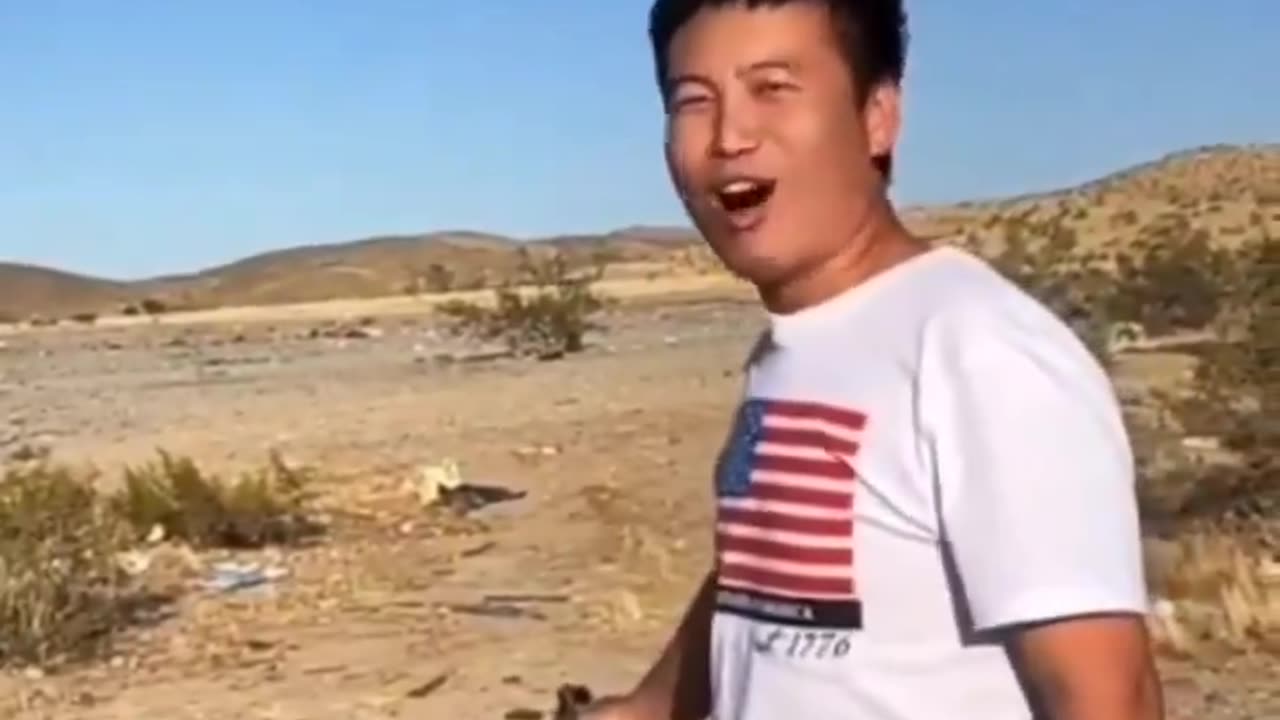 An Asian man, firing his weapon, declares a dark promise to conquer America