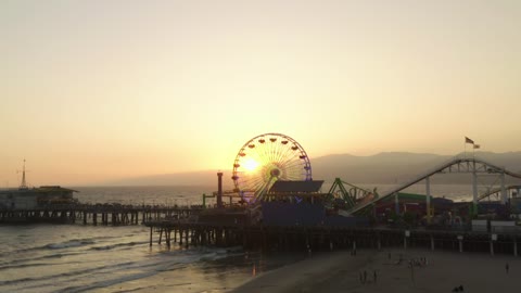 Amusement park by the sea at sunset