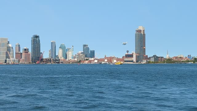 Seaplane Lands in East River, New York City on a Beautiful Day