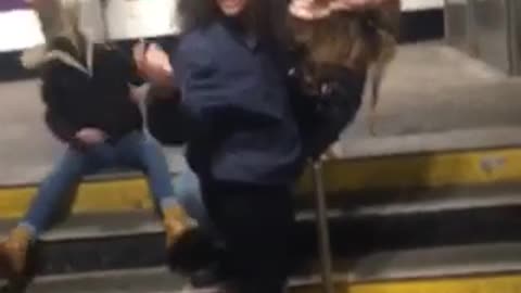 Jacket woman freaks out jumps around on subway steps