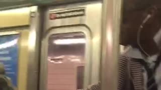 Two people singing on subway train