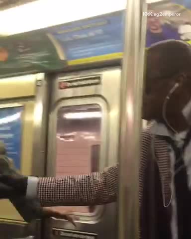 Two people singing on subway train