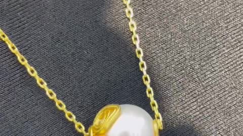 A necklace made of gold and pearls