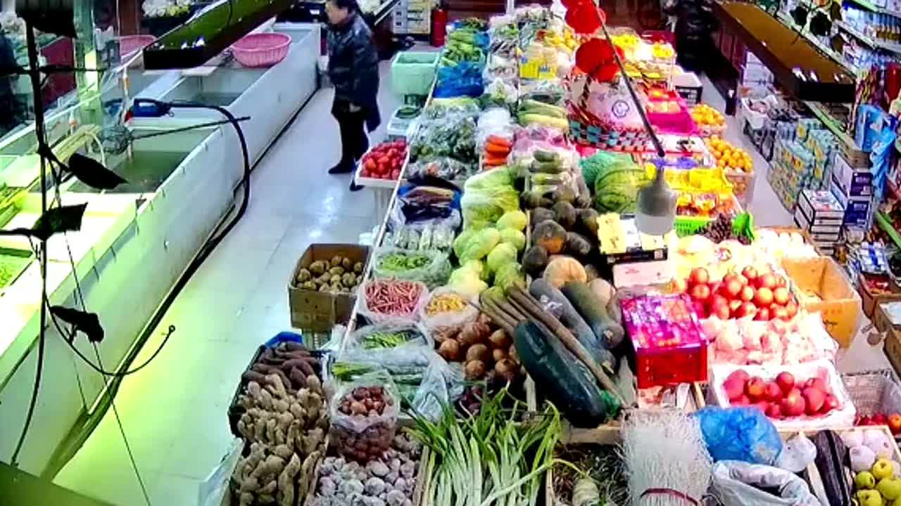 Astonishing moment 'cruel' supermarket owner kicks escaped fish back into tank