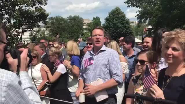Protester being booed after heckling President Trump on South Lawn