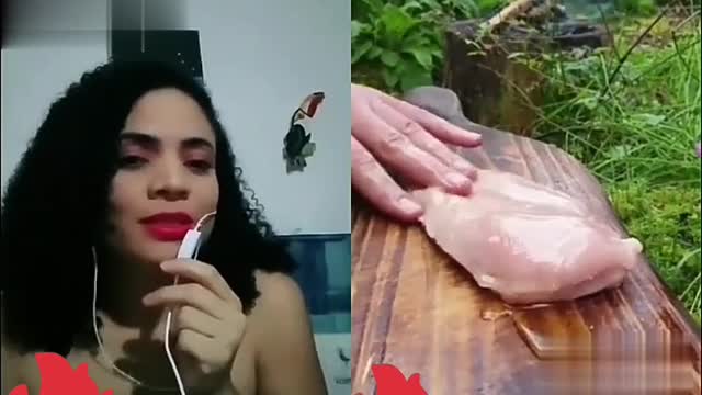 Woman reacting to the cutting of the chicken,and it scares her.