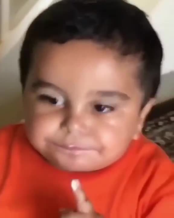 .Kid licking finger saying meow