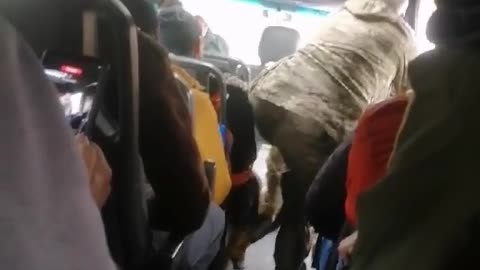 The Ukrainian is so eager to go to the front that the military officer has to calm him down.